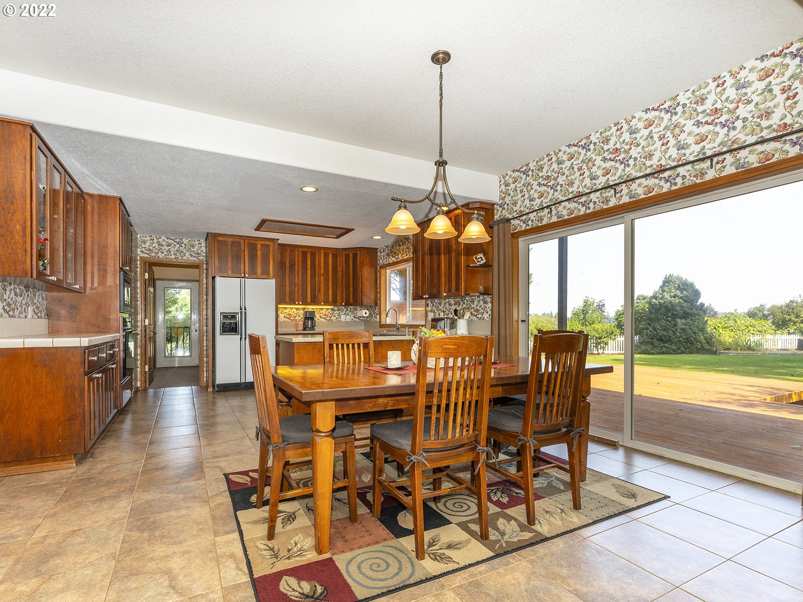 2286 South 31st Court Ridgefield, WA 98642 - Photo 7 of 31 a view of a dining room and livingroom with furniture wooden floor a chandelier