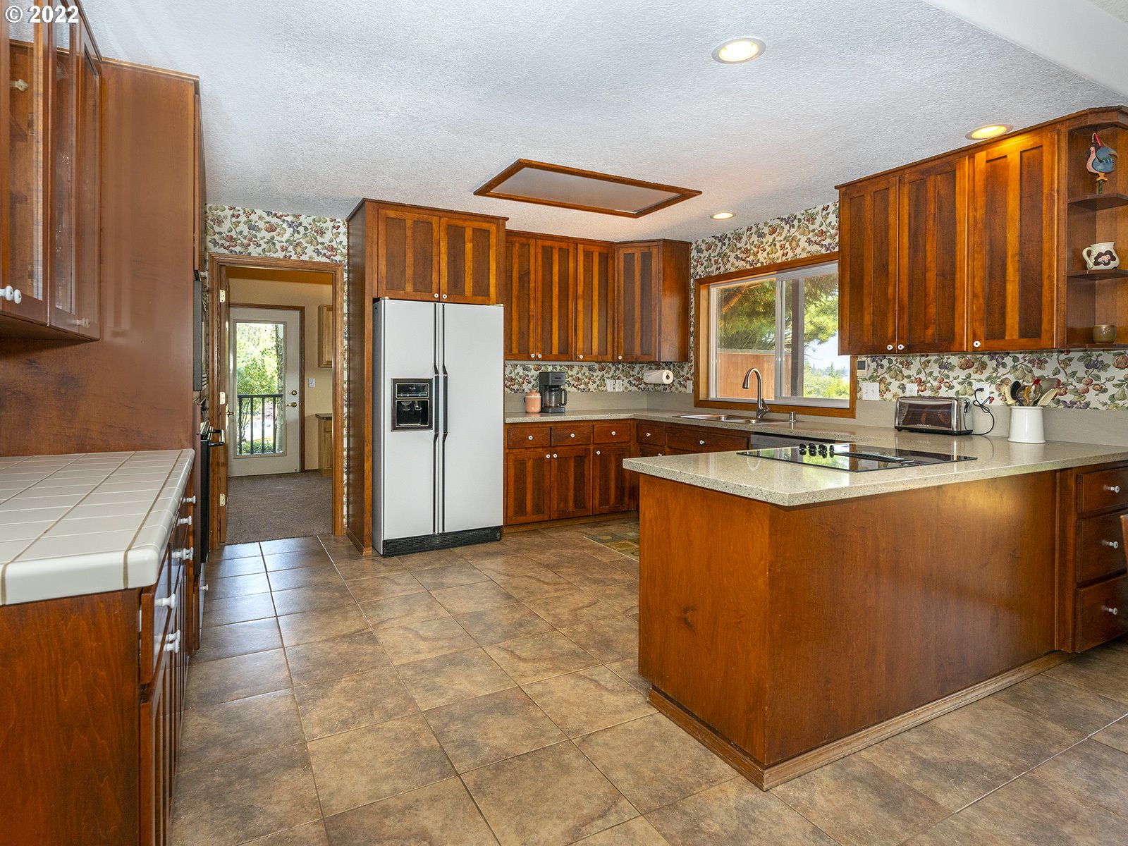 2286 South 31st Court Ridgefield, WA 98642 - Photo 8 of 31 a kitchen with stainless steel appliances granite countertop a stove a sink and a refrigerator
