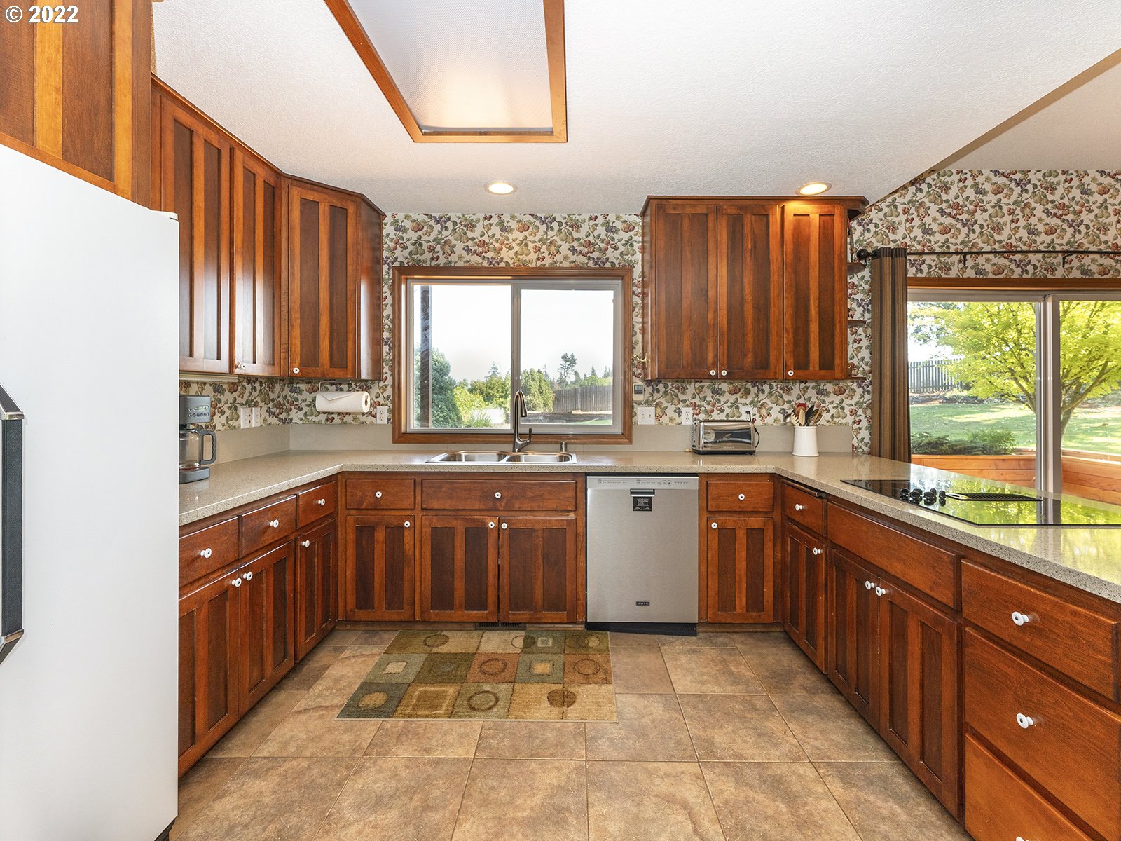 2286 South 31st Court Ridgefield, WA 98642 - Photo 9 of 31 a kitchen with stainless steel appliances granite countertop wooden cabinets a sink and a large window