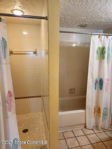 a bathroom with a shower and a bath tub