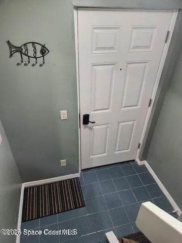 a view of wooden door and entryway