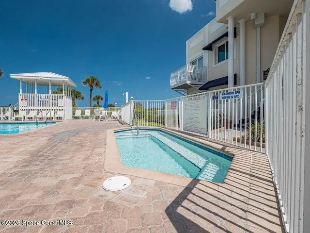 a view of a house with backyard and porch