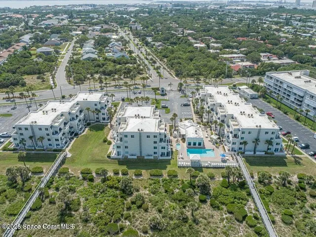 an aerial view of residential houses with outdoor space
