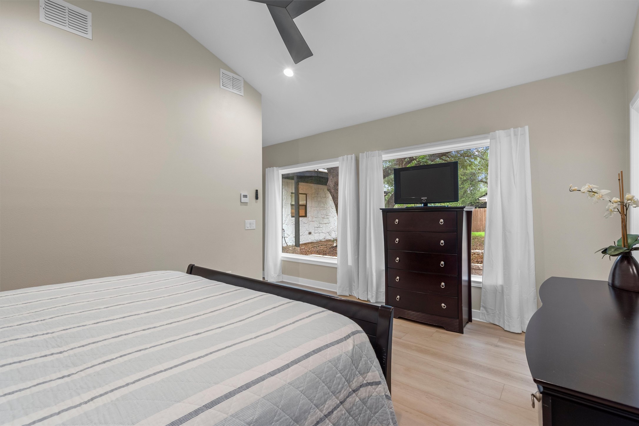 307 Hurst Creek Road Austin, TX 78734 - Photo 17 of 40 Vaulted ceiling bedroom with light wood-finish flooring, recessed lighting, and a ceiling fan