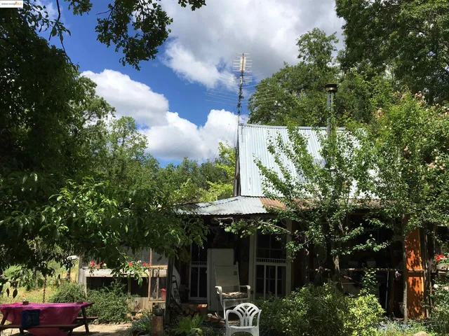 a view of a patio with table and chairs and potted plants