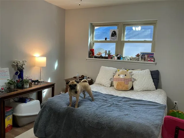 a bedroom with a bed and window