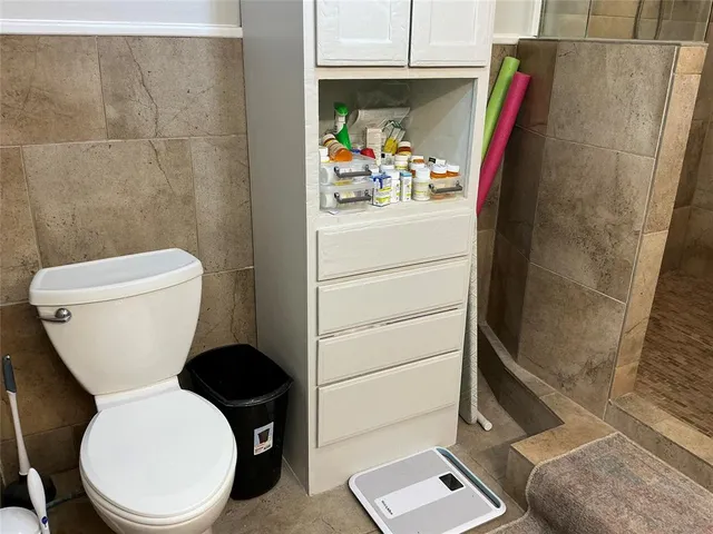 a white toilet sitting next to a bathroom sink