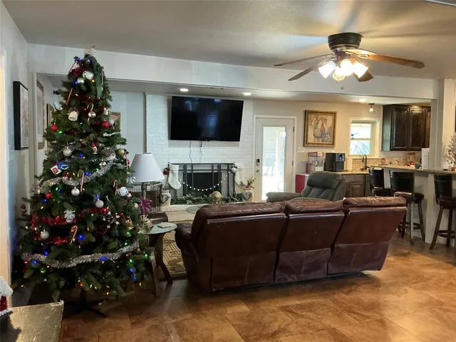 a living room with fireplace furniture and a flat screen tv