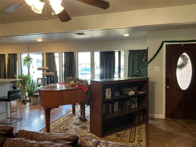 a living room with furniture a window and wooden floor