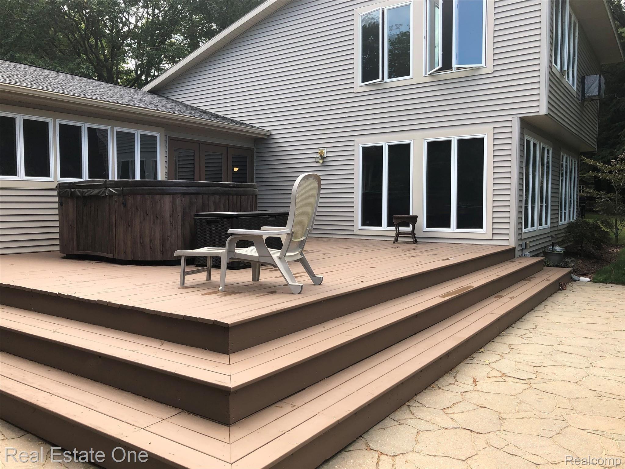 2722 Piney Ridge Road Ludington, MI 49431 - Photo 7 of 64 Newly refinished deck and paver patio. Electric outlets added at both sides of deck.