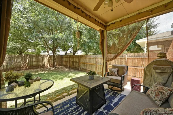 a backyard of a house with table and chairs