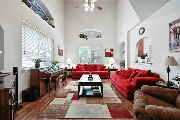 a living room with furniture a rug and a chandelier