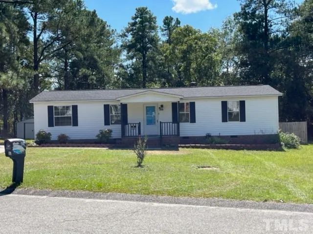 a front view of a house with a yard and swimming pool