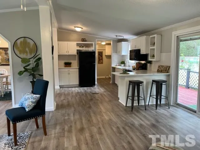 a living room with furniture a rug and a flat screen tv