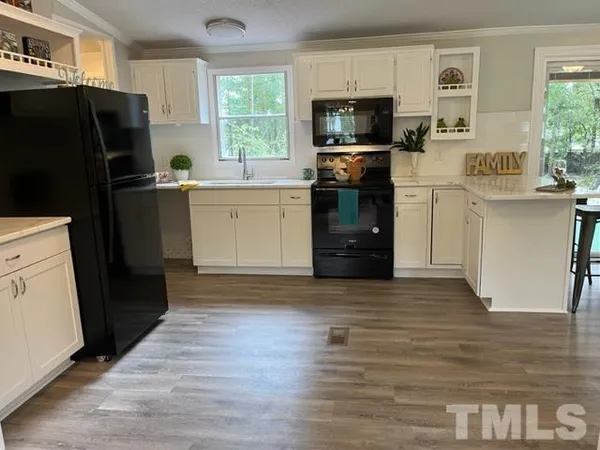 a kitchen with a refrigerator stove and sink