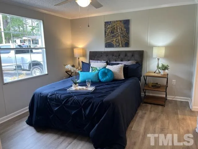 a bed sitting in a bedroom next to a window