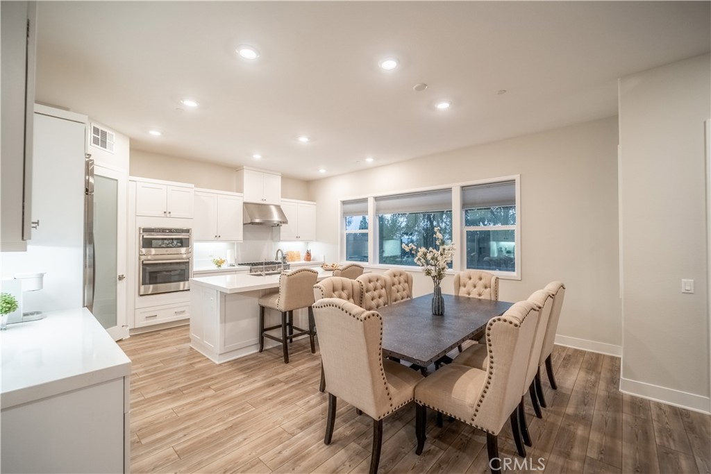 599 Serrano Summit Drive Lake Forest, CA 92630 - Photo 4 of 31 a view of a dining room with furniture window and wooden floor