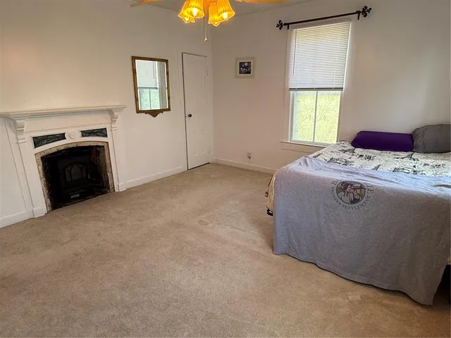 a living room with a bed furniture and a window