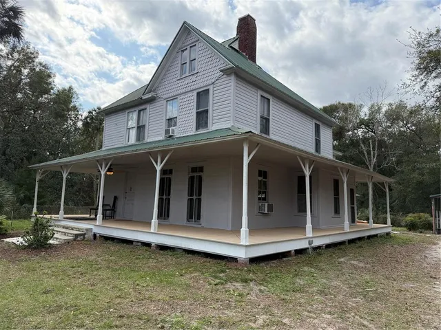 a view of a deck with wooden floor and outdoor seating