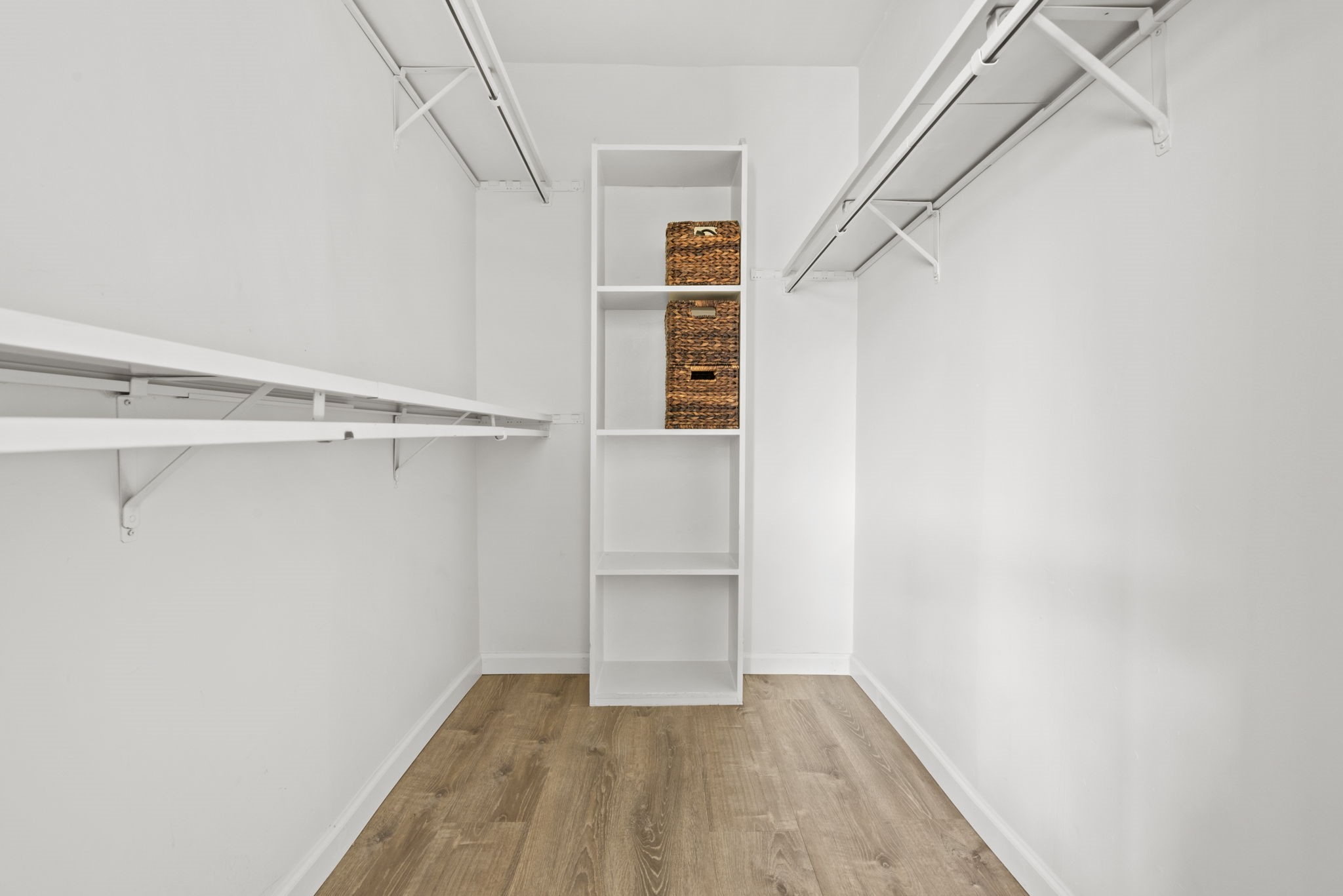 1115 Augusta Drive, Unit 26 Houston, TX 77057 - Photo 12 of 23 Spacious walk-in closet with custom shelving, dual hanging rods, and built-in storage — designed for effortless organization and everyday ease.