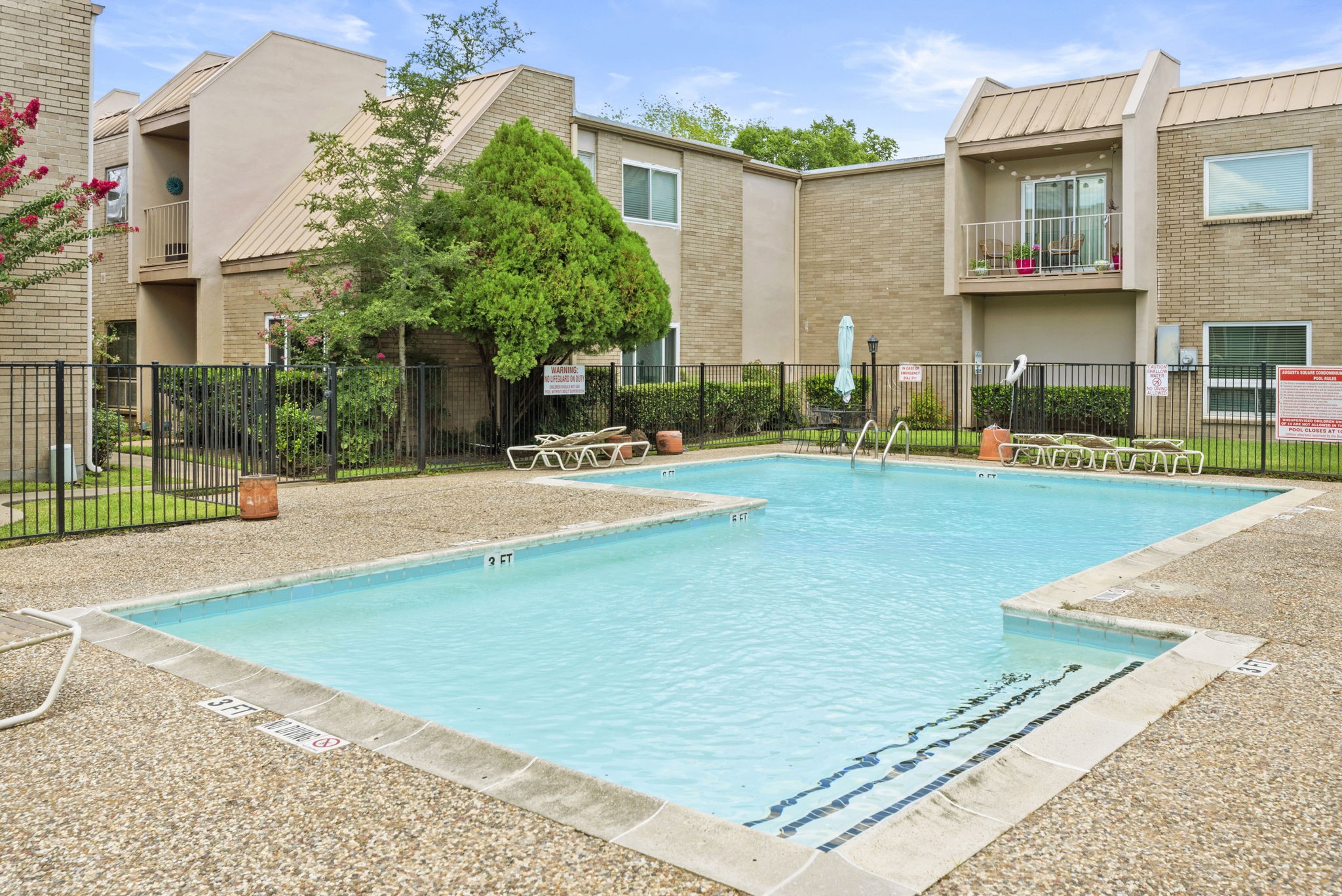 1115 Augusta Drive, Unit 26 Houston, TX 77057 - Photo 19 of 23 Beautifully landscaped grounds with lush greenery and a secure pool area — perfect for relaxing weekends and social gatherings.