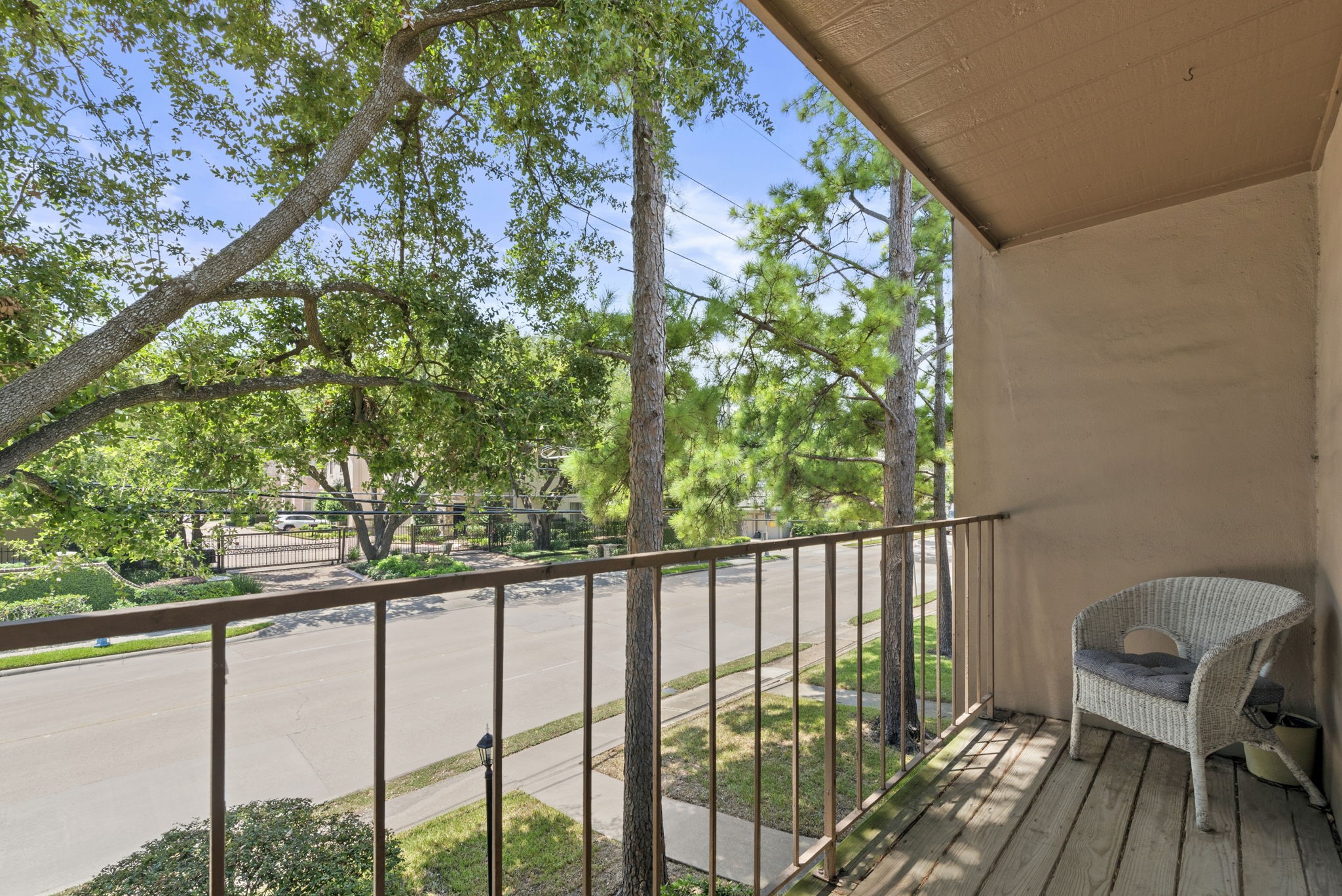 1115 Augusta Drive, Unit 26 Houston, TX 77057 - Photo 2 of 23 Private balcony with treetop views and space to unwind — perfect for morning coffee or evening relaxation in a peaceful, shaded setting.
