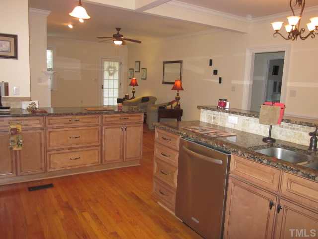 1115 Wake Forest Road, Unit A Raleigh, NC 27604 - Photo 13 of 25 a kitchen with granite countertop a sink and cabinets