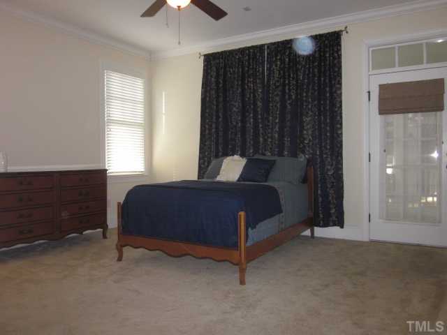1115 Wake Forest Road, Unit A Raleigh, NC 27604 - Photo 17 of 25 a bedroom with a bed and a chandelier fan