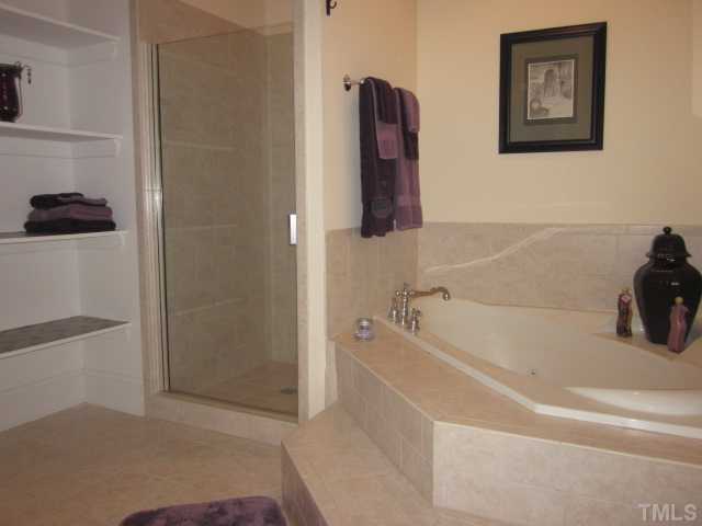 1115 Wake Forest Road, Unit A Raleigh, NC 27604 - Photo 19 of 25 a bathroom with a bathtub and a shower