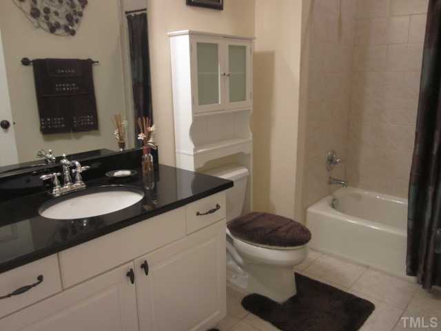 1115 Wake Forest Road, Unit A Raleigh, NC 27604 - Photo 22 of 25 a bathroom with a sink a toilet and a bathtub