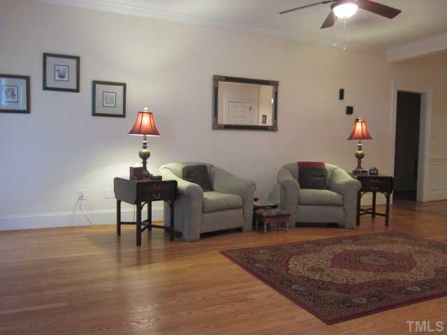 1115 Wake Forest Road, Unit A Raleigh, NC 27604 - Photo 10 of 25 a living room with furniture and a chandelier