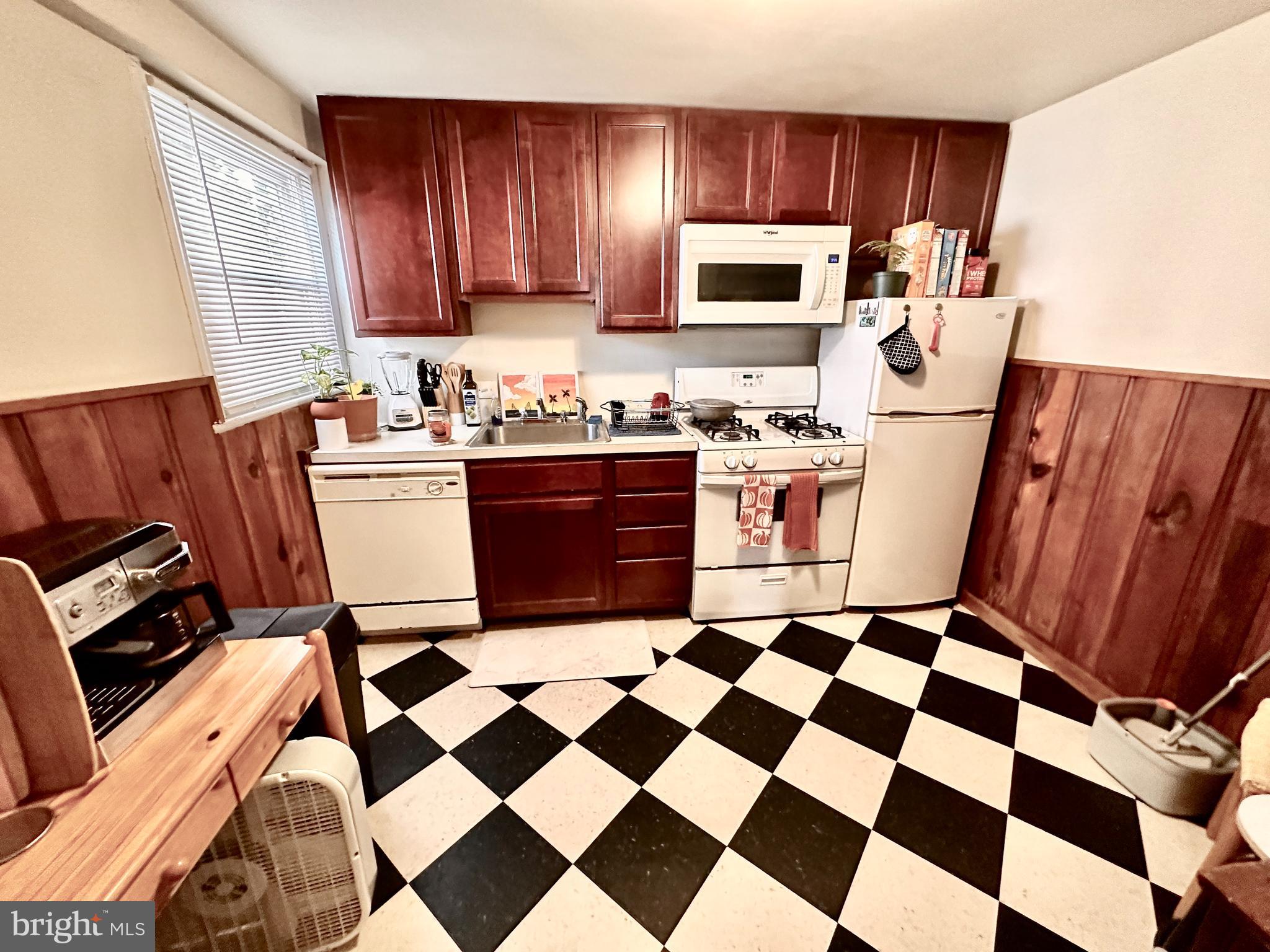243 West Rittenhouse Street, Unit 2C Philadelphia, PA 19144 - Photo 5 of 9 a kitchen with stainless steel appliances granite countertop a refrigerator stove and sink