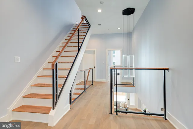 a view of entryway and hall with wooden floor
