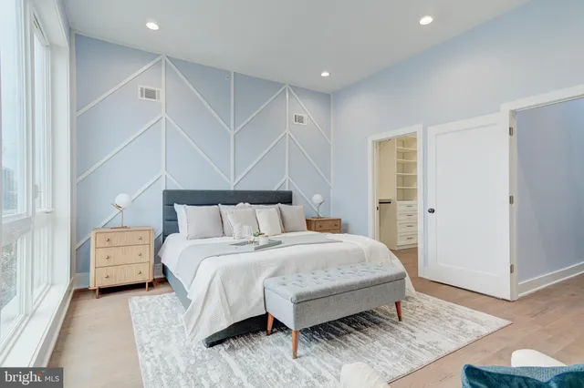 a bedroom with a bed and a night stand