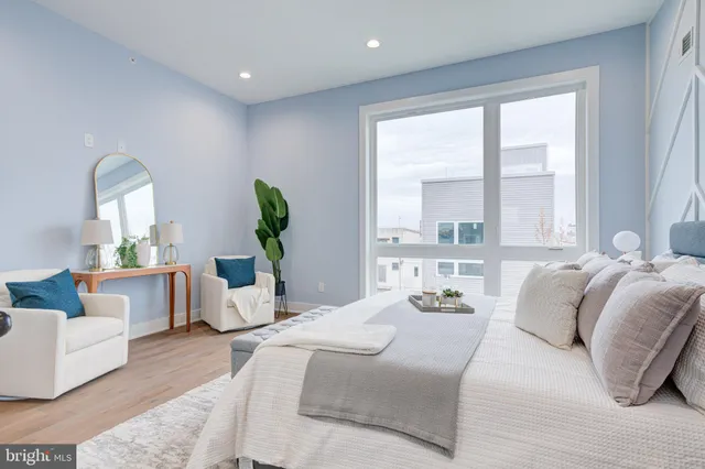 a bedroom with a bed windows and couch