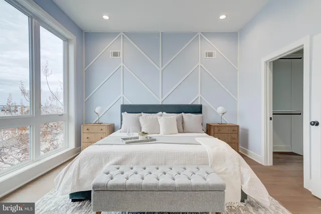 a large white bed in a white room