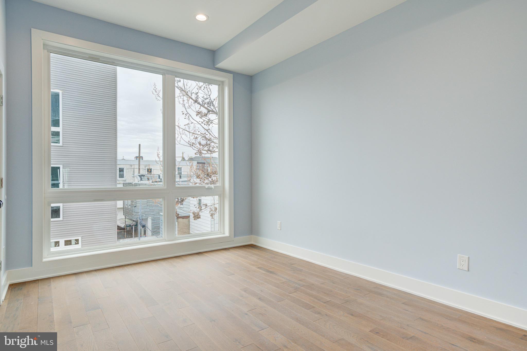 2318 East Hazzard Street Philadelphia, PA 19125 - Photo 19 of 44 an empty room with wooden floor and windows