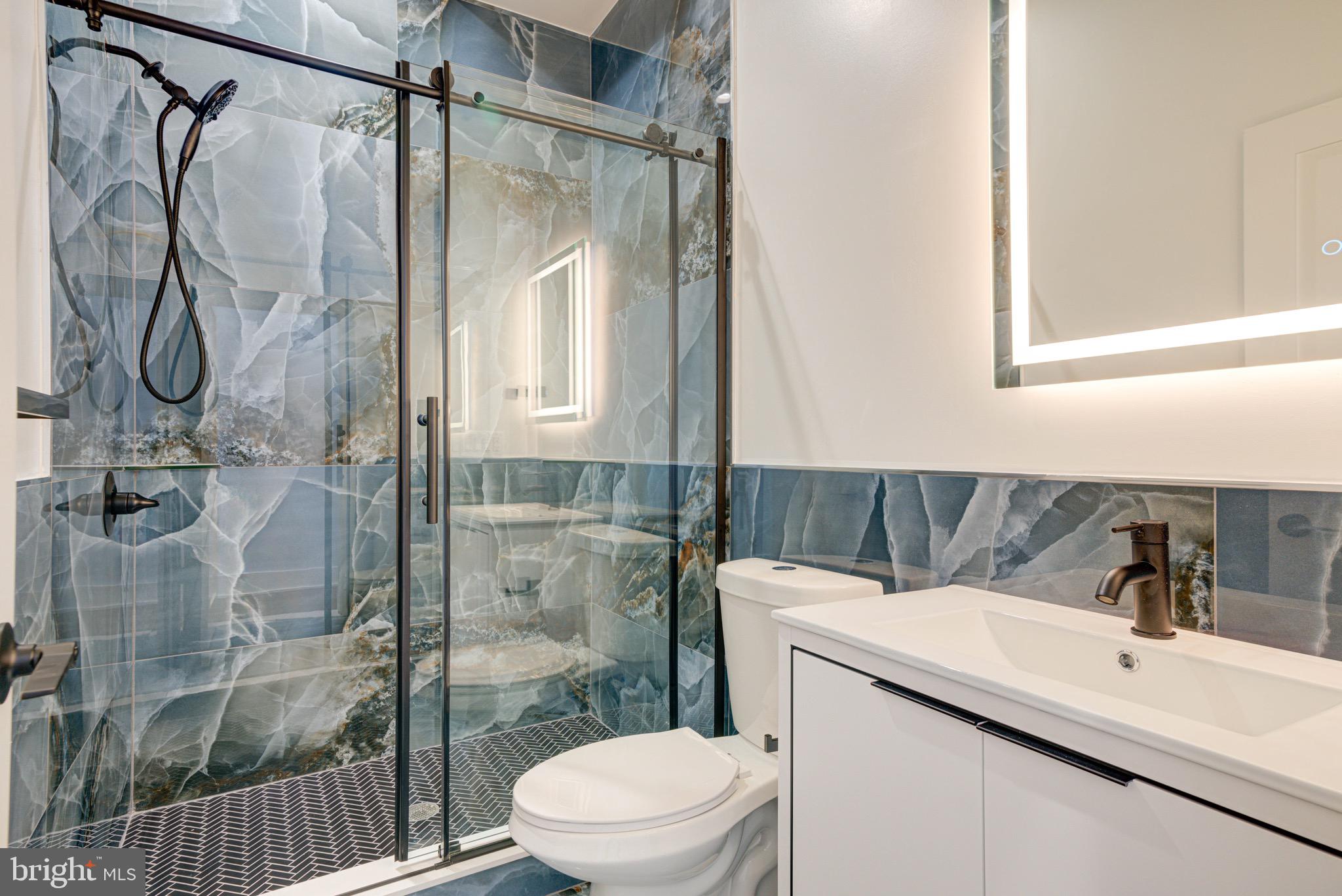 2318 East Hazzard Street Philadelphia, PA 19125 - Photo 30 of 44 a bathroom with a granite countertop sink toilet and shower
