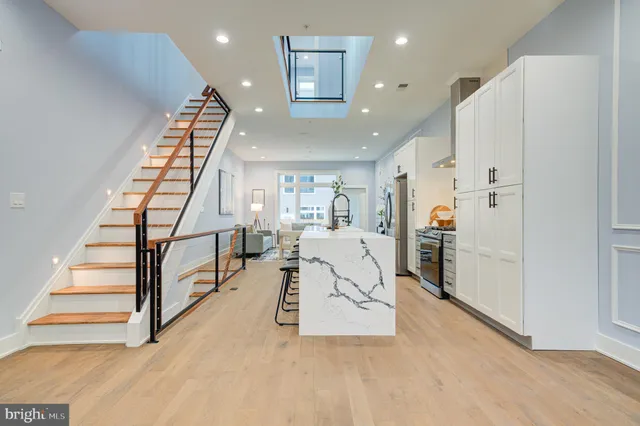 a view of entryway and hall with wooden floor