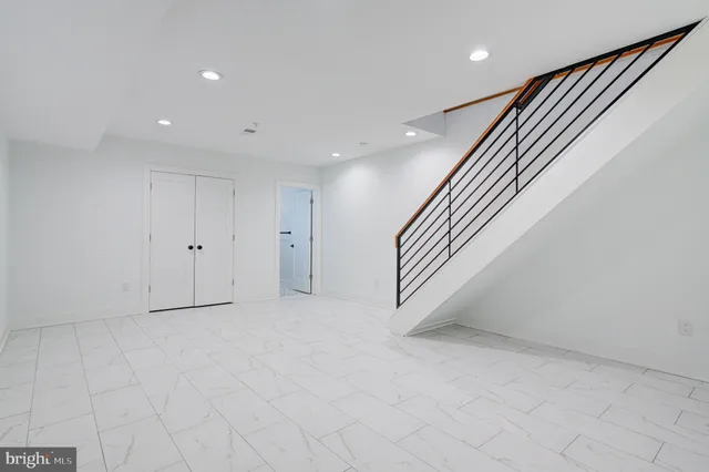 a view of staircase with rug door