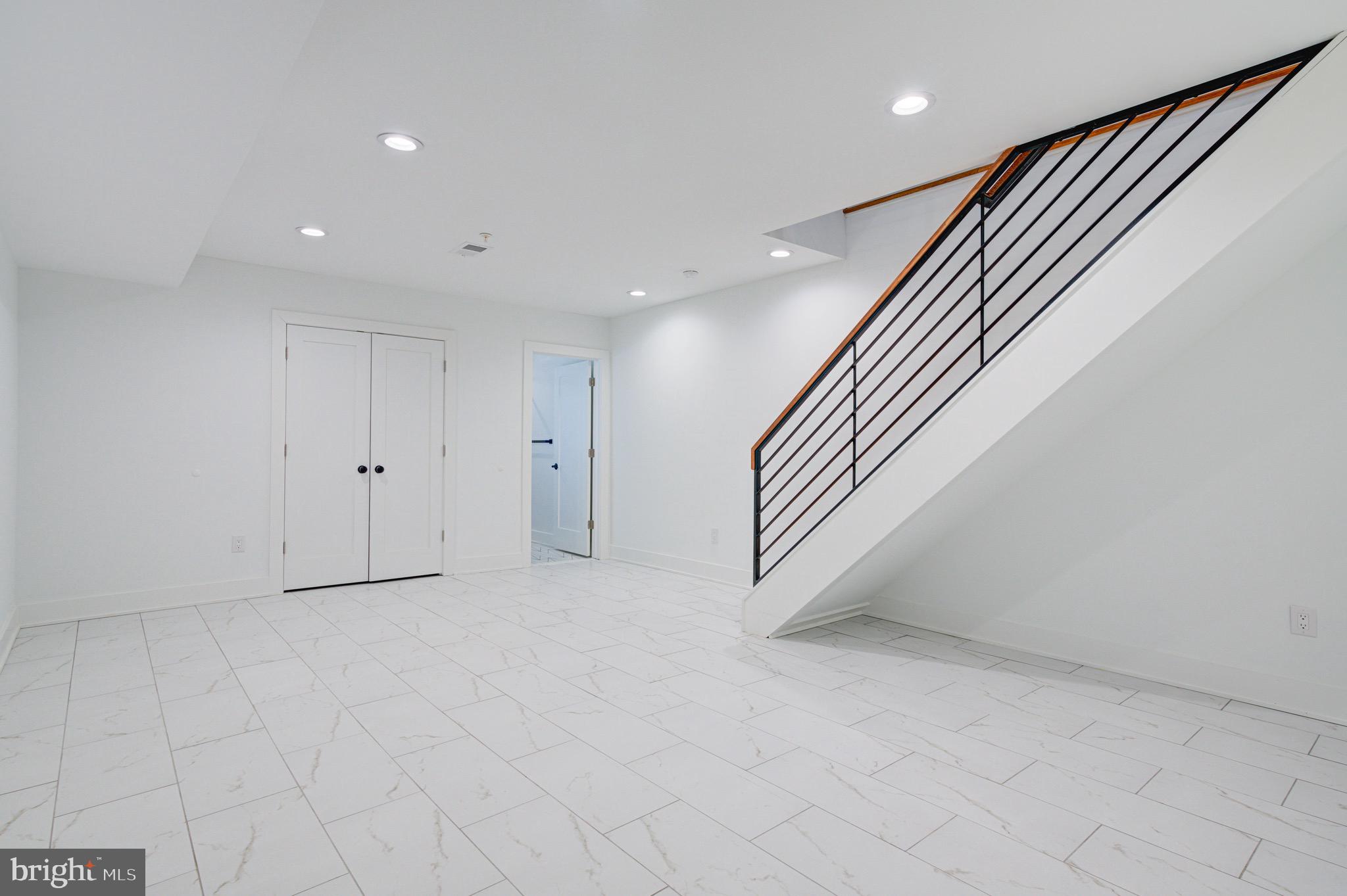2318 East Hazzard Street Philadelphia, PA 19125 - Photo 34 of 44 an empty room with white walls and stairs