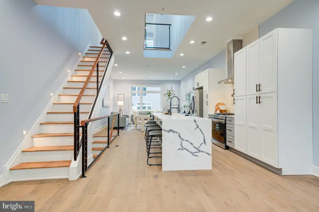 a view of a kitchen with furniture and wooden floor