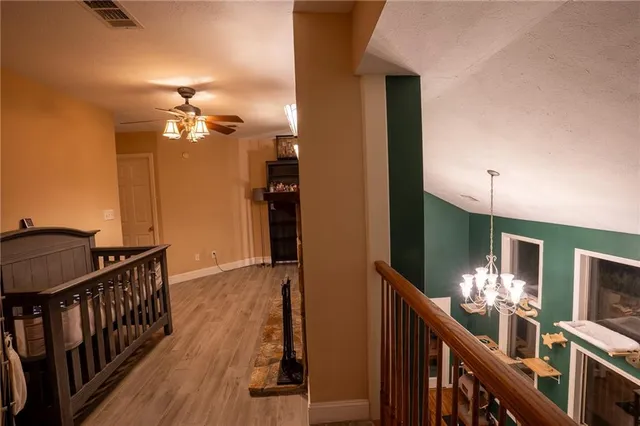 a view of a hallway to a livingroom with furniture