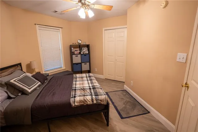 a bedroom with a bed and wooden floor