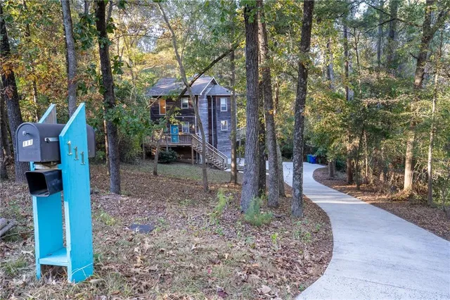 a backyard of a house with barbeque oven table and chairs