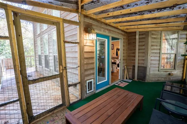 a backyard of a house with barbeque oven table and chairs