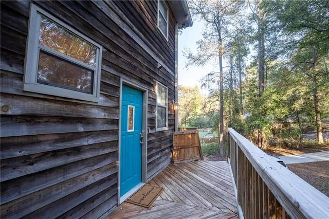a balcony with chairs and wooden floor