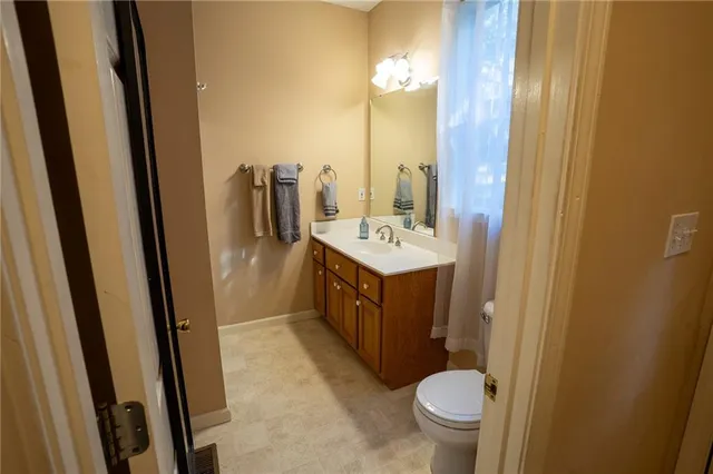 a bathroom with a sink a toilet and a mirror