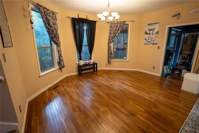 a view of a room with wooden floor and windows