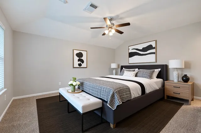 an empty room with a window and a fan